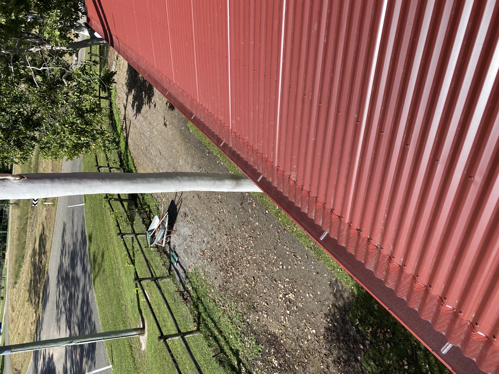 LBC gutter guard installed neatly along a red Colorbond roof